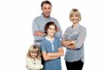 Happy Family Posing With Arms Crossed Stock Photo