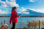 Tourist With Baggage And Map At Fuji Mountain, Kawaguchiko In Japan Stock Photo