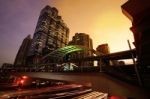 Cityscape Modern Building At Sunset And Cloudy Sky.traffic In Th Stock Photo