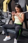 Woman Using Mobile Phone On A Break In Health Club Stock Photo