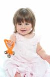 Sweet Little Girl With A Rattle Stock Photo