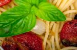 Spaghetti Pasta With Baked Cherry Tomatoes And Basil Stock Photo