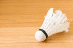 Close Up White Shuttlecock On Wooden Background Stock Photo