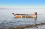 Old Fisher Boat With Engine Near Beach Stock Photo