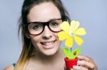 Beautiful Young Woman Showing One Artificial Daisy Stock Photo