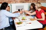 Family Raising A Toast Before Dinner Stock Photo