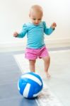 Baby Girl Learning To Walk At Home Stock Photo