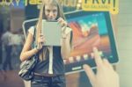 Young Woman With Tablet Computer Walking On Street Stock Photo