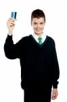 School Boy Holding Credit Card Stock Photo