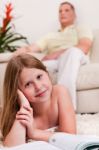 Little Girl Lying With Book Stock Photo