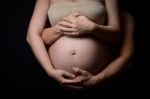 Hands Of Pregnant Woman And Her Husband On Belly Stock Photo