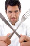 Chef With Cutlery Looking At Camera Stock Photo