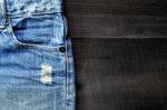 Jeans Lack On The Wooden Floor Stock Photo