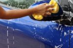 Outdoor Blue Car Wash With Yellow Sponge Stock Photo