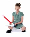 Sitting Schoolgirl Doing Homework Stock Photo