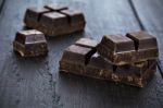 Dark Chocolate Pieces On Wooden Table Background Stock Photo