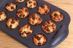 Muffins With Chocolate Chips In Baking Tray Stock Photo