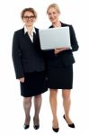 Senior Businesswomen Posing With Laptop Stock Photo