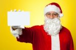 Saint Nick Flashing A Blank Placard To The Camera Stock Photo