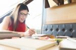 Young Woman Enjoying Reading Book Sitting Near Window Relaxing I Stock Photo