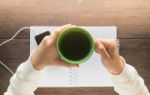 Working Creative Table And Hot Green Tea Drinking Stock Photo