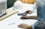 Architects Engineer Discussing At The Table With Blueprint - Clo Stock Photo