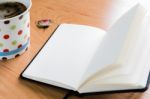 Coffee Cup And Notebook On Wooden Table With Copy Space Stock Photo