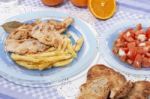 Turkey Steak With French Fries And Tomato Salad Stock Photo