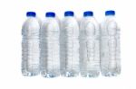 Row Of Plastic Water Bottles Isolated On A White Background Stock Photo