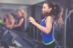 Beautiful Brunette On A Treadmill Stock Photo