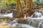 The Water Flowing Over Rocks And Trees Down A Waterfall At Huay Mae Khamin Waterfall National Park ,kanchana Buri In Thailand Stock Photo