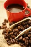 A Red Cup And Coffee Beans Stock Photo