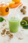 Kiwi Juice, Nuts And Fresh Fruits On Wooden Background Stock Photo