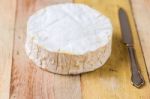 Camembert Cheese And Vintage Knife On Wooden Table Stock Photo