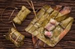 Khao Tom Mat - Thai Dessert - Sticky Rice, Banana And Black Beans Wrapped In Banana Leaf Stock Photo