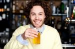 Positive Young Man Holding A Glass Of Beer Stock Photo