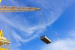 Crane Boom While Lifting Basket In The Sea Stock Photo