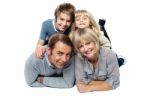 Adorable Young Kids Piled On Top Of Their Parents Stock Photo