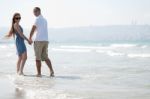 Couple Walking At Beach Stock Photo