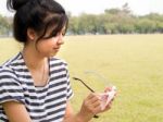 Girl Cleaning Her Glasses Stock Photo