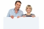 Lovely Couple Standing Behind Blank Billboard Stock Photo