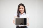 Portrait Of Thai High School Student Uniform Beautiful Girl Using Her Tablet Stock Photo