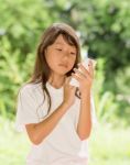 Asia Girl Use Smart Phone In Garden Stock Photo