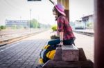 Girl Tourist Sitting On A Bench In A Train Station Stock Photo