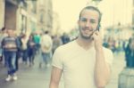 Man With Mobile Phone Walking On Street Stock Photo