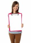 Teen Showing Paper On Clipboard Stock Photo