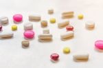 Top View Of The Pills On The White Background, The Drug And Capsule Pills On The Floor Stock Photo