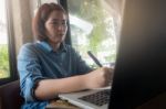 Young Asian Woman Working In Coffee Shop Stock Photo