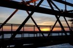 Silhouette Of Structure Of The Bridge In Sun Set At The Sea Stock Photo