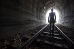 Man In A Tunnel Looking Towards The Light Stock Photo